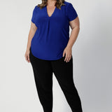 Full body image of 40 year old woman wears classic black Indi Pant. High quality fabric used to make these garments is dry touch jersey. Made in Australia for woman in Australia & New Zealand. Sizes range from 8 - 24 with plus and petite friendly sizes considered and ready to shop.