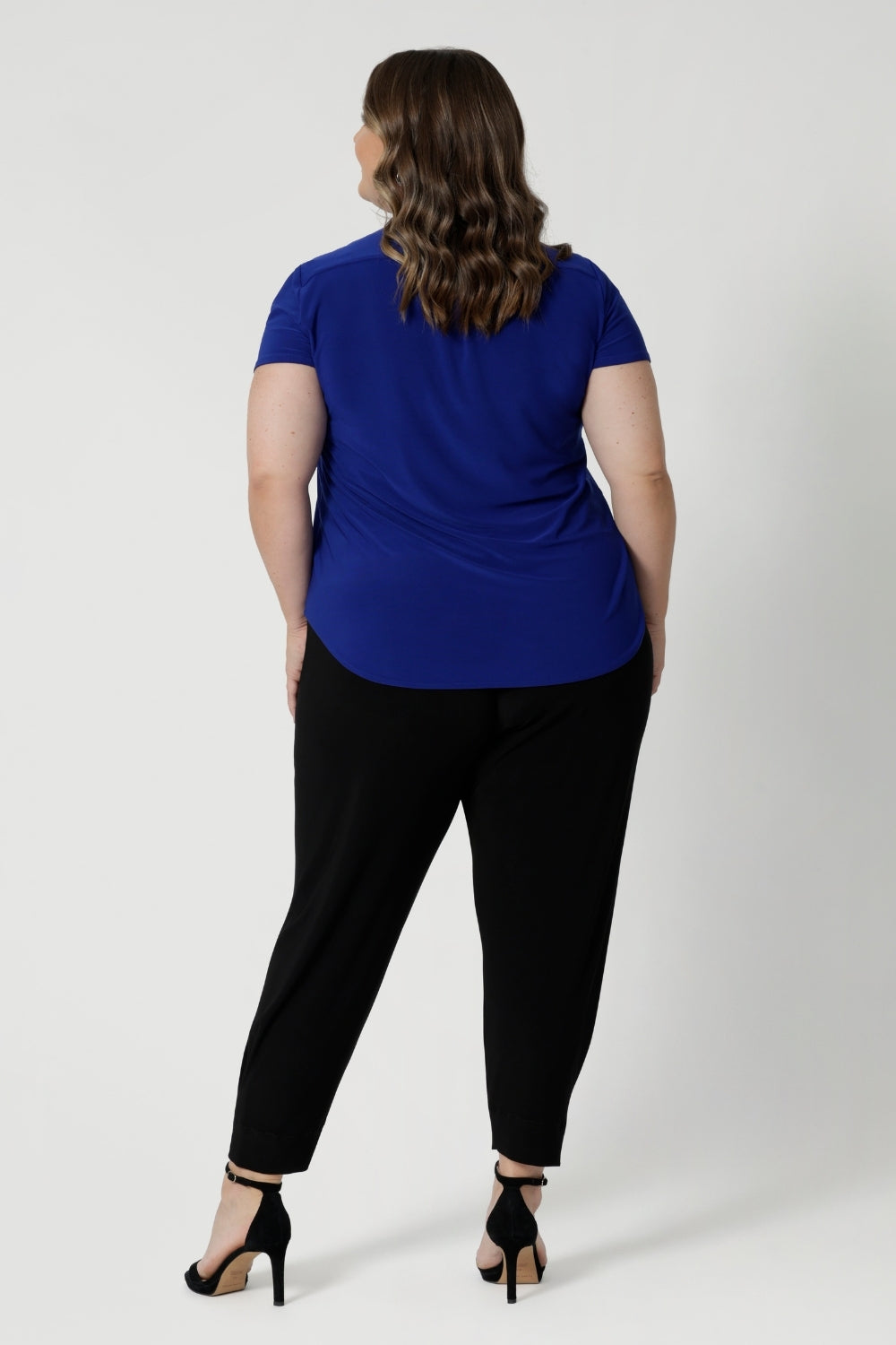 Back view of pants for travel, these dropped crotch, cropped leg, single seam black pants, shown in a size 18, are made stretchy jersey for ultimate comfort. Australian made by Australian and New Zealand women's clothing brand, L&F shop these comfy navy pants for your travel and capsule wardrobe now!