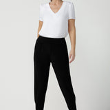 Great pants for travel, these dropped crotch, cropped leg, single seam black pants are made stretchy jersey for ultimate comfort. Worn with white bamboo jersey top , shop these comfy navy pants for your travel and capsule wardrobe now!