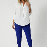 Size 12 woman wears pants that have been designed with stretch for added flexibility, ensuring they move comfortably with your body. The fabric's breathable qualities make them ideal for wearing year-round, keeping you cool and comfortable, even in warmer conditions. Additionally, they are made from easy-care fabric that is low-maintenance and ideal for busy lifestyles—simply machine wash and wear. available now in sizes 8-24.
