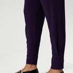 Close up image of Indi Pant in Amethyst in the long length, featuring the tapered leg
ankle cuffs and tailored tuck detail of the 7/8 length leg. Available in sizes 8-24 and 2 lengths to accommodate for all heights and styles. 