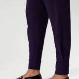 Close up image of Indi Pant in Amethyst in the long length, featuring the tapered leg
ankle cuffs and tailored tuck detail of the 7/8 length leg. Available in sizes 8-24 and 2 lengths to accommodate for all heights and styles. 