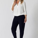 Great pants for travel, these dropped crotch, cropped leg, single seam navy pants are made stretchy jersey for ultimate comfort. Worn with white bamboo jersey top , shop these comfy navy pants for your travel and capsule wardrobe now!