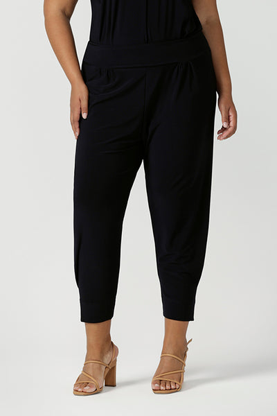 Great pants for travel, these dropped crotch, cropped leg, single seam navy pants are made stretchy jersey for ultimate comfort. Worn with white bamboo jersey top , shop these comfy navy pants for your travel and capsule wardrobe now!