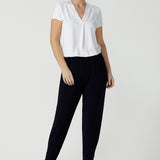 Great pants for travel, these dropped crotch, cropped leg, single seam navy pants are made stretchy jersey for ultimate comfort. Worn with white bamboo jersey top , shop these comfy navy pants for your travel and capsule wardrobe now!