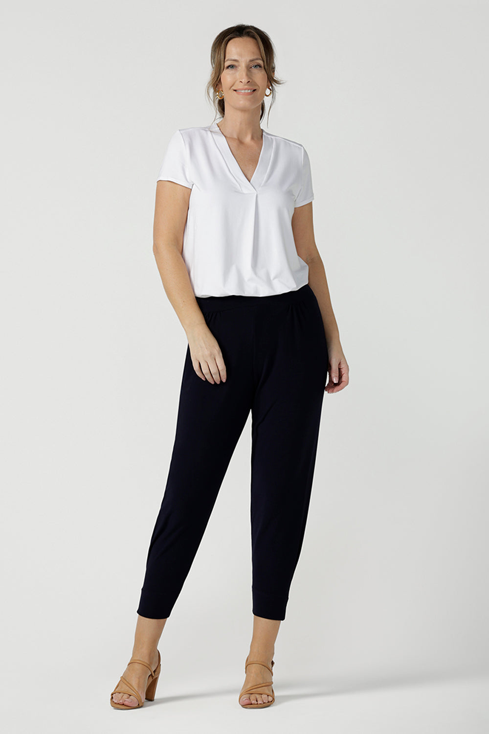 Great pants for travel, these dropped crotch, cropped leg, single seam navy pants are made stretchy jersey for ultimate comfort. Worn with white bamboo jersey top , shop these comfy navy pants for your travel and capsule wardrobe now!