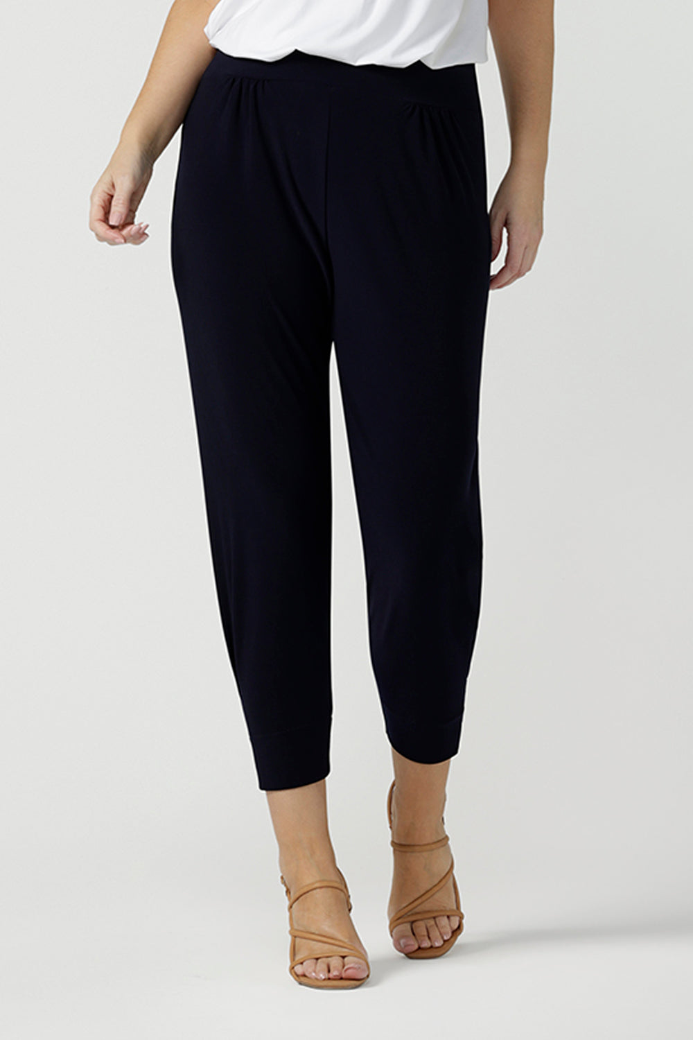 Great pants for travel, these dropped crotch, cropped leg, single seam navy pants are made stretchy jersey for ultimate comfort. Worn with white bamboo jersey top , shop these comfy navy pants for your travel and capsule wardrobe now!