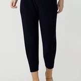 Great pants for travel, these dropped crotch, cropped leg, single seam navy pants are made stretchy jersey for ultimate comfort. Worn with white bamboo jersey top , shop these comfy navy pants for your travel and capsule wardrobe now!