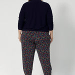 Tapped leg pant seen on plus sized model paired with navy jacket. These pants are versatile enough to be dressed up or down, making them a must-have for travel, work, or casual outings. Whether you're on the go or looking for a chic and comfy addition to your wardrobe. Available in 8-24.