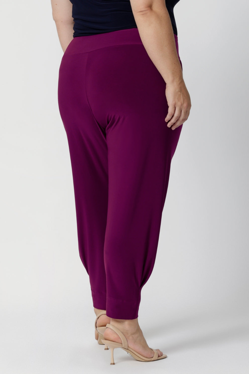 Close up image of Indi Pants in Magenta  featuring the single inside-seam leg that creates a sleek, streamlined effect, and the tapered leg complements the ankle cuffs. Easy care pants come in two different lengths to accommodate a variety of heights, available in sizes 8-24.