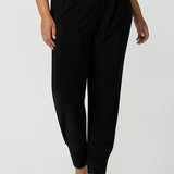  Designed as a full length travel pant for tall women. A size 18 curvy woman wears great pants for travel, these dropped crotch, single seam black pants are made stretchy jersey for ultimate comfort. Worn with a white bamboo jersey top , shop these comfy black pants for your travel and capsule wardrobe now!