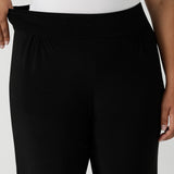 Close up of the stretchy waistband of great pants for travel, these dropped crotch, single seam black pants are made stretchy jersey for ultimate comfort. shop these comfy black pants for your travel and capsule wardrobe now!