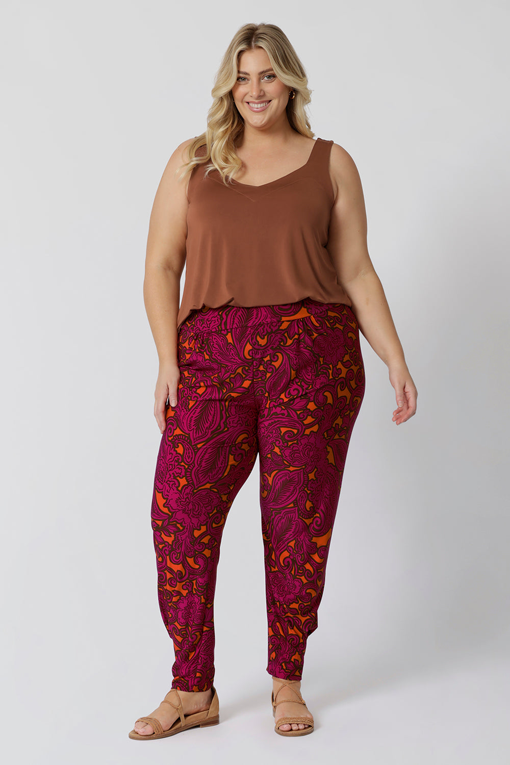 Plus sized model wears paisley printed travel pants. The relaxed, effortless fit offers plenty of room for movement, while the elegant print and comfortable fabric combine for a pant that’s as stylish as it is practical. Perfect for both casual outings and adventures, this pant will keep you looking and feeling cool all season long. Sizes 8-24 available