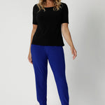 Size 12 model wears off duty pants that feature stretch and breathability. These travel ready pants provide flexibility and comfort throughout the day, whether you're walking through an airport or sitting for long periods. The design features a flattering waistband and a streamlined fit, making them versatile for both casual and more polished looks. Sizes 8-24.