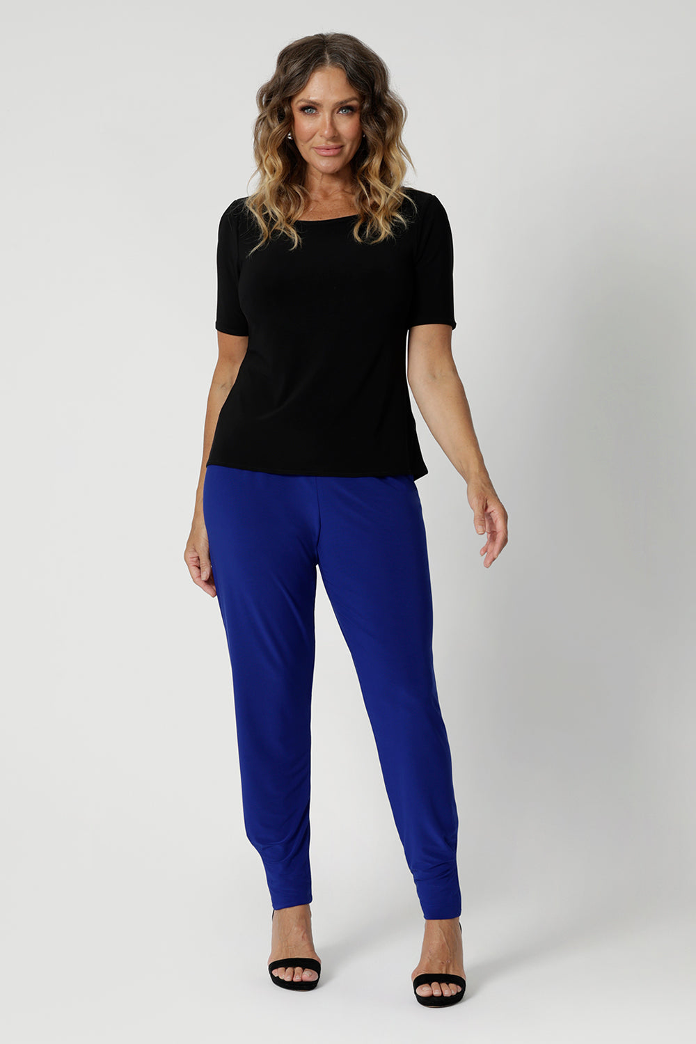 Size 12 model wears off duty pants that feature stretch and breathability. These travel ready pants provide flexibility and comfort throughout the day, whether you're walking through an airport or sitting for long periods. The design features a flattering waistband and a streamlined fit, making them versatile for both casual and more polished looks. Sizes 8-24.