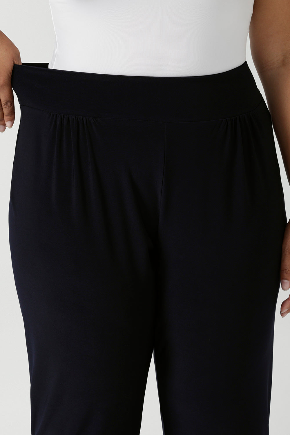 A close up of the stretchy waistband of great pants for travel, these dropped crotch, single seam navy pants are made stretchy jersey for ultimate comfort. shop these comfy navy pants for your travel and capsule wardrobe now! Available in sizes 8-24.