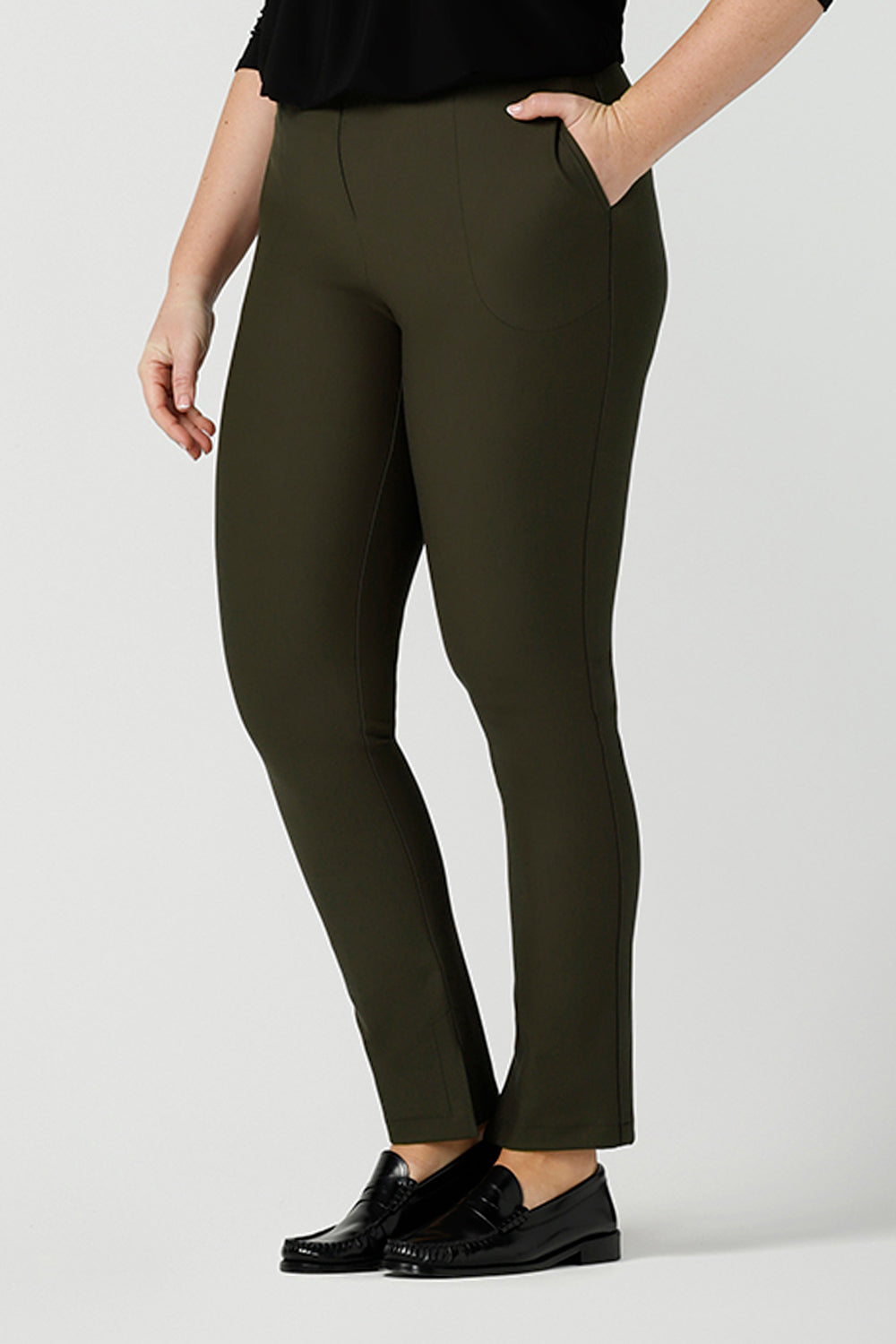 Smart-casual, professional pants for women, these olive green slim leg pants are shown on a size 12, curvy woman. Made in Australia by online ladies clothing brand, Leina & Fleur shop these comfortable trousers in petite to plus sizes.