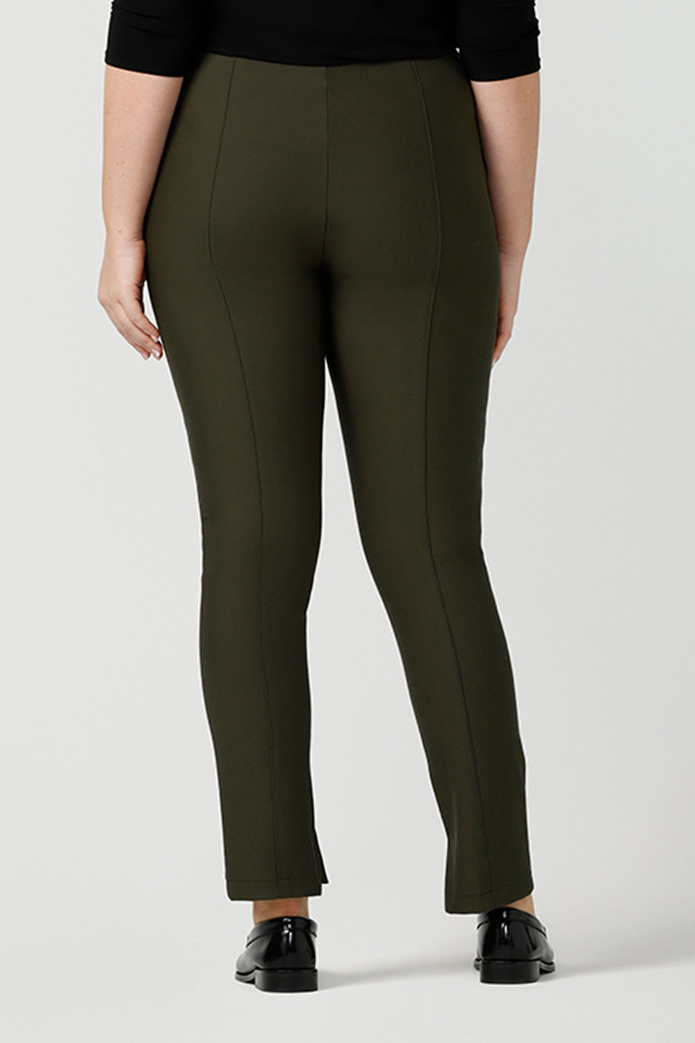 Back view of good smart-casual, professional pants for curvy women, these olive green slim leg pants are shown on a size 12, curvy woman. Made in Australia by online ladies clothing brand, Leina & Fleur, shop these ethical, comfortable trousers in petite to plus sizes.