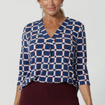 The Jaime Top is the perfect addition to your workwear wardrobe, offering effortless style and versatility that seamlessly transitions from office wear to weekend casual. Crafted from a luxurious deep blue dry-touch jersey fabric, this top offers a soft stretch that provides all-day comfort while maintaining a polished, structured look. 
