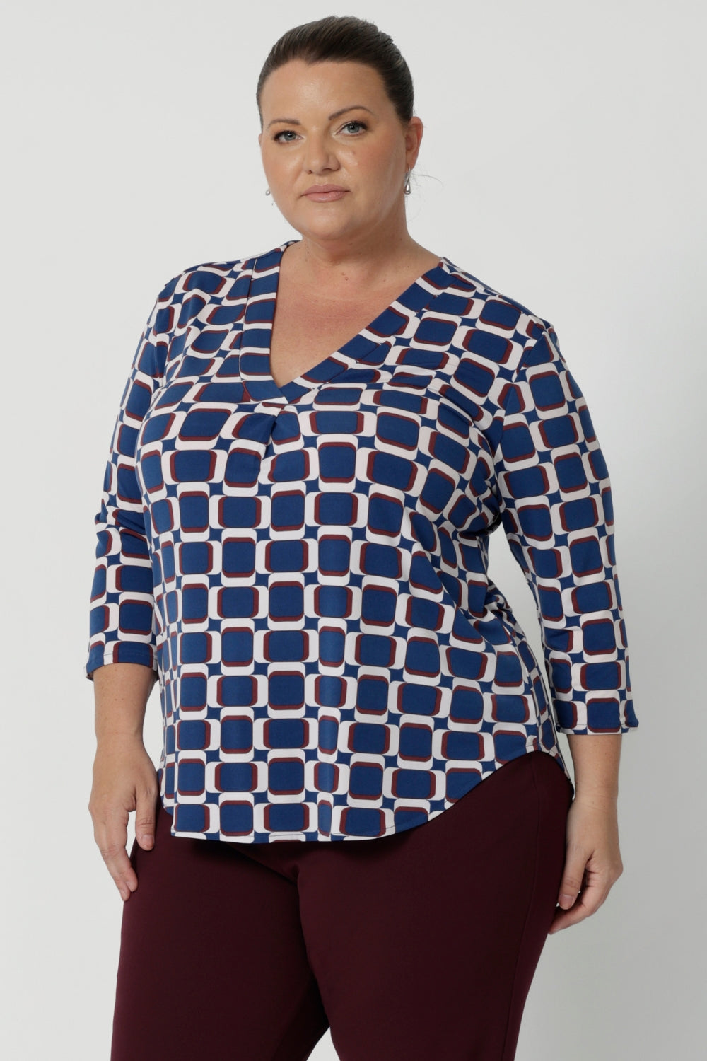 The V-neckline is complemented by a tailored tuck at the centre front, adding a modern and refined touch to this collarless shirt. The 3/4 length sleeves offer the perfect balance of coverage and breathability, making it suitable for both cooler and warmer months. A shoulder yoke with a centre-back tailored tuck adds an extra dimension to the top, creating a flattering and sophisticated fit.