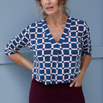 The V-neckline is complemented by a tailored tuck at the centre front, adding a modern and refined touch to this collarless shirt. The 3/4 length sleeves offer the perfect balance of coverage and breathability, making it suitable for both cooler and warmer months. 