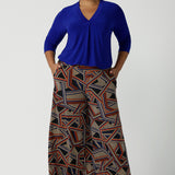 Size 16 woman wears the Dany Culotte in Trixie, a printed Jersey work pant with a geometric pattern. Wide leg with functional pockets and wide waistband. Cropped length and petite height friendly. Made in Australia for women size 8 - 24.