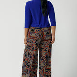 Back view of a size 16 woman wears the Dany Culotte in Trixie, a printed Jersey work pant with a geometric pattern. Wide leg with functional pockets and wide waistband. Cropped length and petite height friendly. Made in Australia for women size 8 - 24.