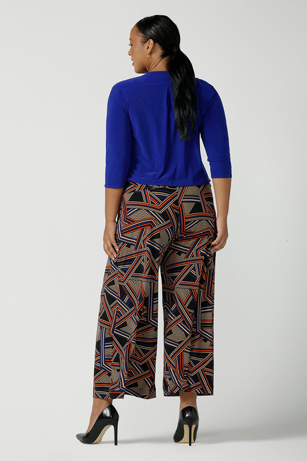 Size 16 Woman wears the Jaime top in Cobalt, a v-neck pleat front top with 3/4 sleeves. Soft Cobalt blue jersey and styled back with black work pants. Styled back with the Dany Culotte in Trixie. Made in Australia for women size 8 - 24