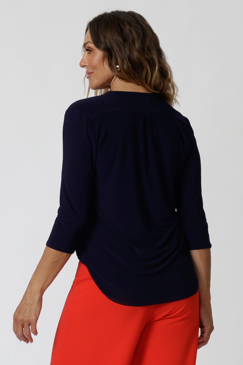 Back View of 40 year old woman wearing navy top. This easy care shirt is made from navy dry touch jersey fabric. Designed in Australia for Australian and New Zealand women. Leina & Fleur is a woman's fashion brand that stock sizes from 8 - 24. Shop this high quality top in Black and Navy