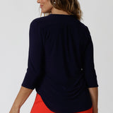 Back View of 40 year old woman wearing navy top. This easy care shirt is made from navy dry touch jersey fabric. Designed in Australia for Australian and New Zealand women. Leina & Fleur is a woman's fashion brand that stock sizes from 8 - 24. Shop this high quality top in Black and Navy