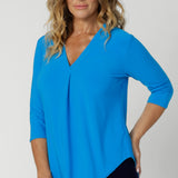 The Jaime Top is the ultimate workwear essential for the modern woman who values both style and practicality. Crafted in a vibrant bright opal colour. This workwear top adds a pop of freshness to any professional wardrobe. Made from a dry-touch jersey fabric with a soft stretch, it provides both comfort and a flattering fit, perfect for long days at the office or on the move.