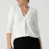 A size 10 woman wears the Jaime top in Vanilla. A comfortable workwear top for women in soft dry touch easy care versey. Featuring a v-neck with pleat front and bind. 3/4 sleeve and made in Australia for women size 8 - 24. 