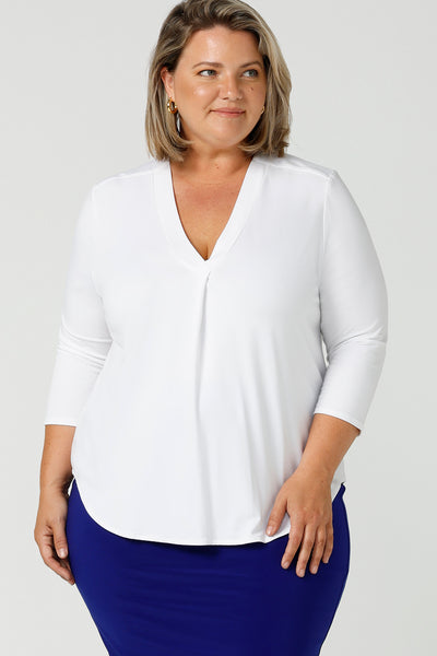 A good white top for your capsule wardrobe, this V-neck , 3/4 sleeve top is made in luxurious white bamboo jersey. Shown on a size 18, plus size woman, this classic top makes a great work blouse. Australian made women's clothing brand, Leina & Fleur, makes white bamboo jersey tops like this and more in inclusive sizes, 8 to 24 for petite to plus size women - shop now in their online fashion boutique!