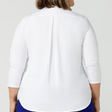 Back view of a good white top for your capsule wardrobe, this V-neck , 3/4 sleeve, white bamboo jersey top has a shoulder yoke and back pleat.  Shown on a size 18, plus size woman, this classic top makes a great work blouse. Made in Australia by Australian andNew Zealand women's clothing brand, Leina & Fleur, this white jersey top is available to shop online in sizes 8 to 24