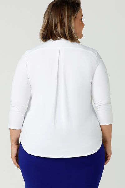 Back view of a good white top for your capsule wardrobe, this V-neck , 3/4 sleeve, white bamboo jersey top has a shoulder yoke and back pleat.  Shown on a size 18, plus size woman, this classic top makes a great work blouse. Made in Australia by Australian andNew Zealand women's clothing brand, Leina & Fleur, this white jersey top is available to shop online in sizes 8 to 24