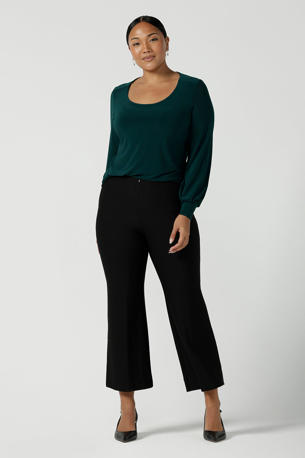 Size 10 woman wears the Jasper top in Aline. A work friendly style and made in Australia for women. Size 8 - 24. Styled back with the Troy pant in black. 