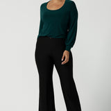 Size 10 woman wears the Jasper top in Aline. A work friendly style and made in Australia for women. Size 8 - 24. Styled back with the Troy pant in black. 