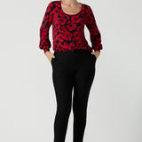 Size 10 woman wears the scoop neck bold poppy top with balloon sleeves. Curved hemline and cuffed sleeves. Made in Australia for women size 8 - 24. Styled back with the Brooklyn pant in black a skinny leg comfortable corporate work pant. 