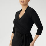 The Jett Dress, crafted from our signature black dry-touch stretch jersey, is the perfect women’s wrap dress for work or events, offering comfort, structure, and a modern silhouette.