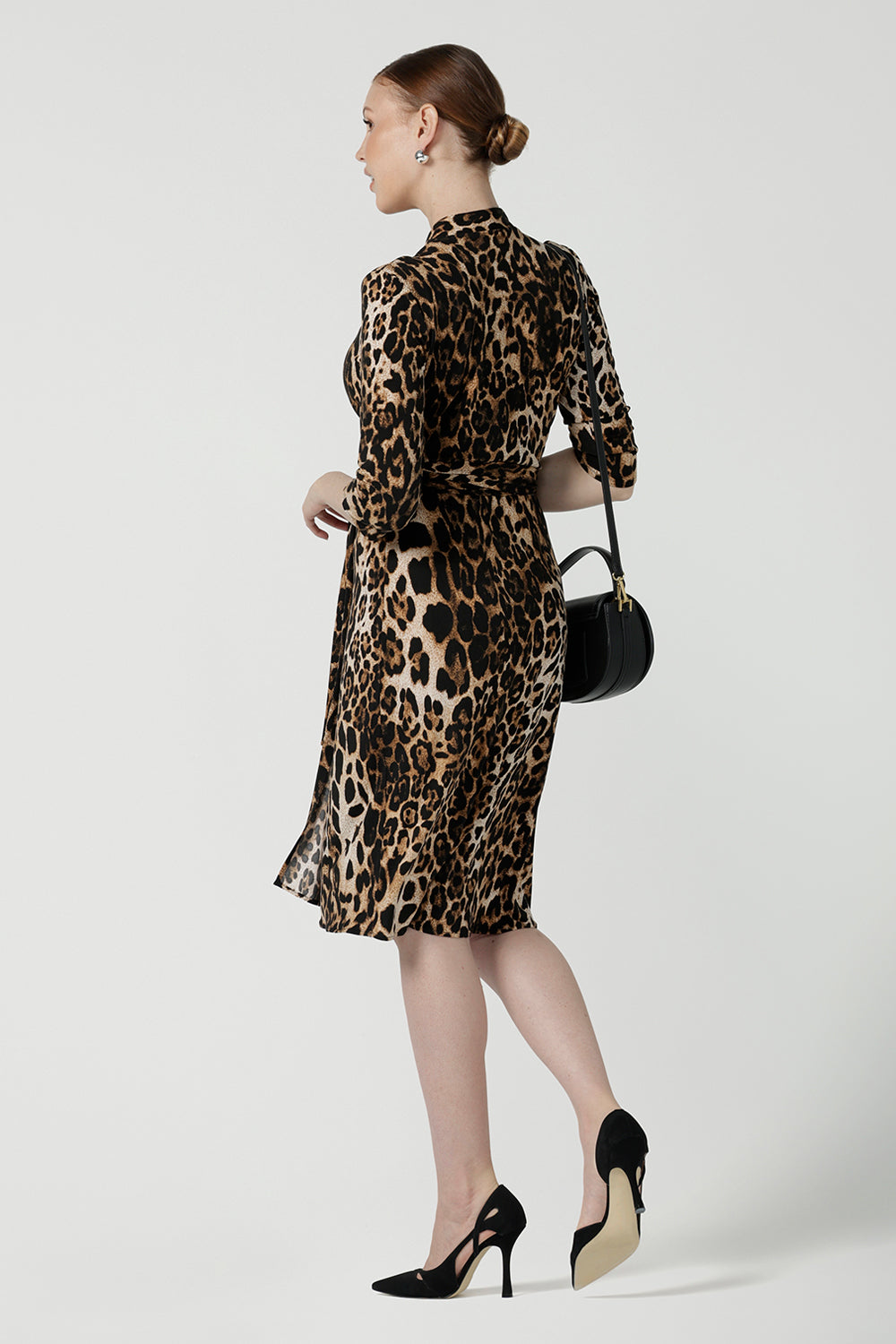 Back view of of a size 10 woman wears the Jett Dress in Gold Leopard. A functioning wrap dress with a tie waist and mandarin collar. Trending Leopard print. Made in Australia for women size 8 - 24. Petite to plus size fashion.