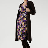 The vibrant painterly-style floral print, rich in purples and soft yellow hues, adds an artistic touch to a timeless silhouette. With its functioning wrap design, extended waist ties, and angular interlined collar, the Jett Dress brings a contemporary edge to your workwear wardrobe