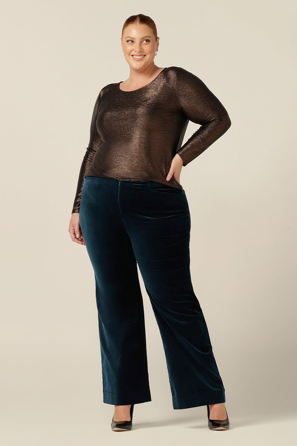 Evening and cocktail wear gets a touch of disco flare for plus size women with these bootcut leg, tailored pants in petrol green velveteen. Worn with a sparkly mocha brown, long sleeve top for eveningwear, these special event pants are made in Australia in sizes 8 to 24.