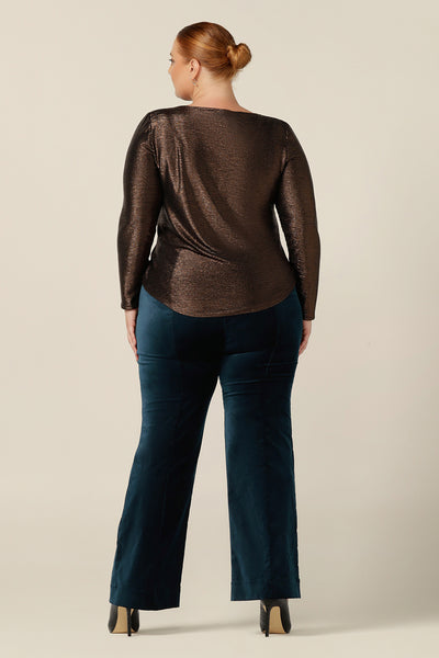 Back view of a size 18, fuller figure woman wearing a sparkly occasionwear top by Australian and New Zealand women's clothing brand, L&F. With a high scoop neck and long sleeves, this shimmering stretch jersey top in Mocha brown is a comfortable evening top for cocktail and event wear.