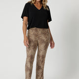 Over 40's model wears easy care pants in gorgeous animal print, made with soft touch jersey fabric. Making it a go to piece for travel and long wear. The soft jersey fabric stretches comfortably to move with you, providing a relaxed fit that's never restrictive. Available in sizes 8-24.