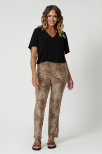 Over 40's model wears easy care pants in gorgeous animal print, made with soft touch jersey fabric. Making it a go to piece for travel and long wear. The soft jersey fabric stretches comfortably to move with you, providing a relaxed fit that's never restrictive. Available in sizes 8-24.