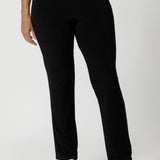 The straight-leg cut is both flattering and versatile, creating a clean, tailored silhouette that works for both casual and elevated looks. Size 12 model pairs black pants with white top & silver sneakers for a casual look.