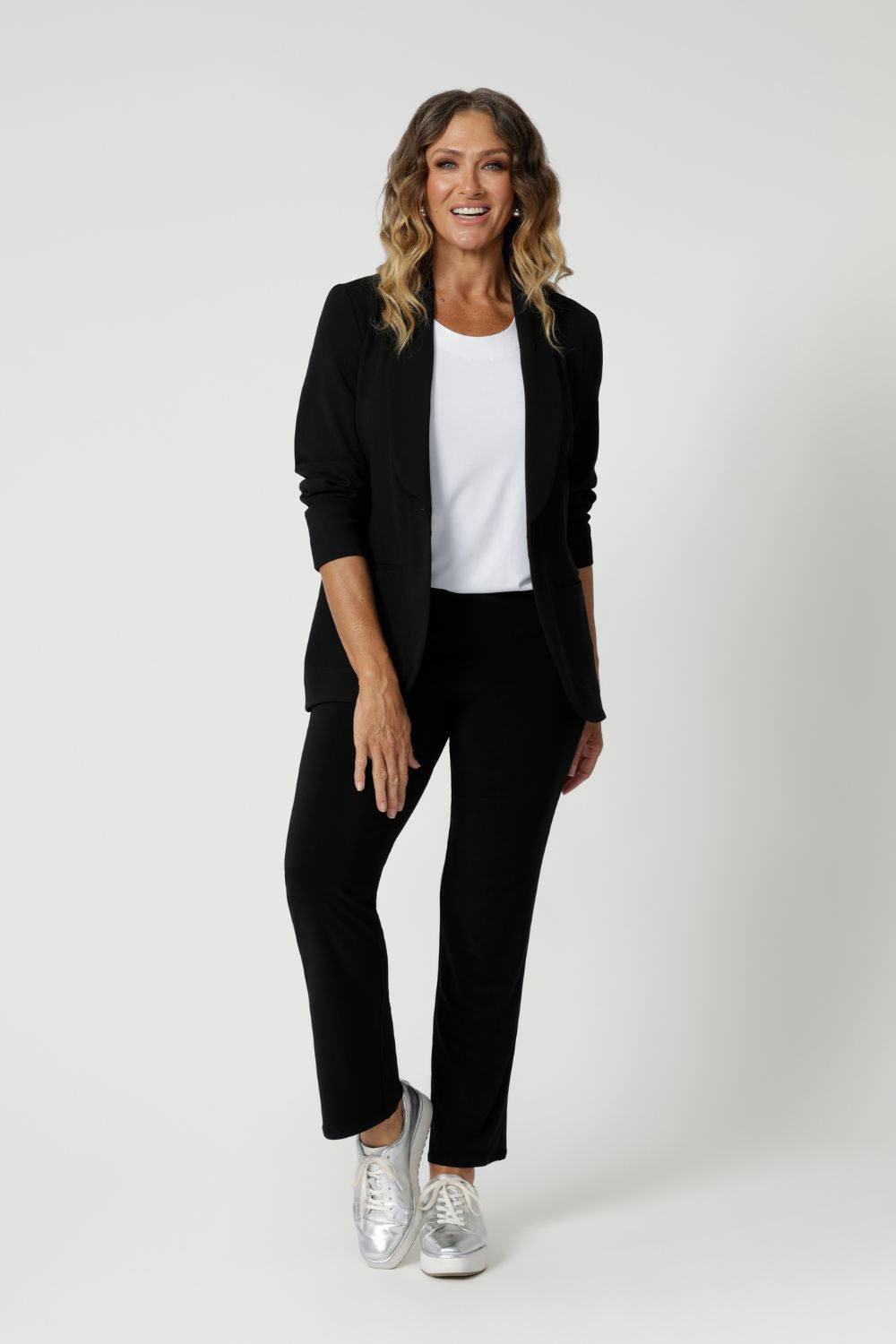 Over 40's woman wears black pants styles perfectly for back-to-work attire. These pants can easily be dressed up with a blouse and heels for an elevated look, or dressed down with a casual top and sneakers for effortless comfort. Australian made soft touch jersey fabric provides comfort in the work place and busy days.