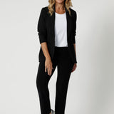 Over 40's woman wears black pants styles perfectly for back-to-work attire. These pants can easily be dressed up with a blouse and heels for an elevated look, or dressed down with a casual top and sneakers for effortless comfort. Australian made soft touch jersey fabric provides comfort in the work place and busy days.