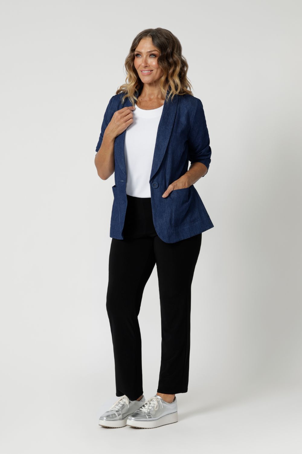 Size 12 model wears easy care black pants with denim blazer for an elevated day to day casual look. The straight-leg cut is both flattering and versatile, creating a clean, tailored silhouette that works for both casual and elevated looks. Joel Pants in black are available in 8-24.