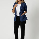 Size 12 model wears easy care black pants with denim blazer for an elevated day to day casual look. The straight-leg cut is both flattering and versatile, creating a clean, tailored silhouette that works for both casual and elevated looks. Joel Pants in black are available in 8-24.